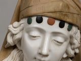 marble bust of a woman wearing a headdress and a veil