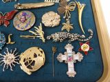 a tray with a variety of brooches on it