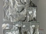 many bags of assorted items hanging on a wall