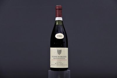 a bottle of wine sitting on top of a black table