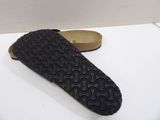 pair of black slippers sitting on top of a white table