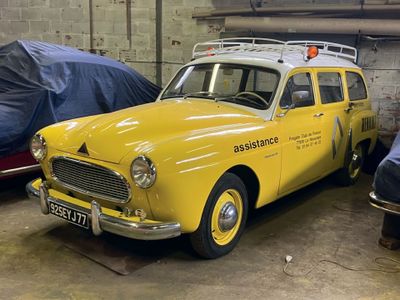 a yellow car parked in a garage next to other cars