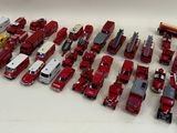 a lot of red and white toy trucks on a table