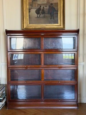 a picture of a dresser in a room with a painting on the wall