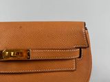 a close up of a brown purse on a white surface