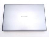 a silver laptop sitting on a white surface