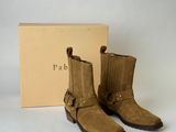 the pair of brown boots are next to a box