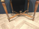 a small table with a mirror on top of it