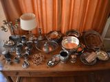 a table with a lot of silver items on it