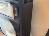 a small black stove sitting next to a wall