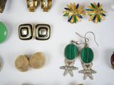 many different types of jewelry on a white surface