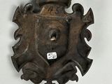 a metal plaque on the wall with a crown on it