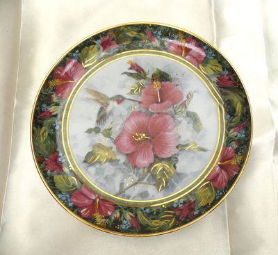 a picture of a plate with a bird and flowers on it