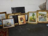 a lot of framed art on the floor in the room