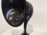 a black gramphone sitting on a table next to a lamp