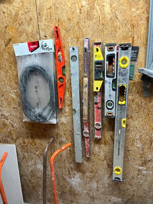 many tools that are hanging on the wall