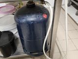 an image of a kitchen with a water tank on the counter