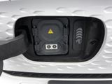 a close up of a car ' s front bumper with a yellow warning sign on it
