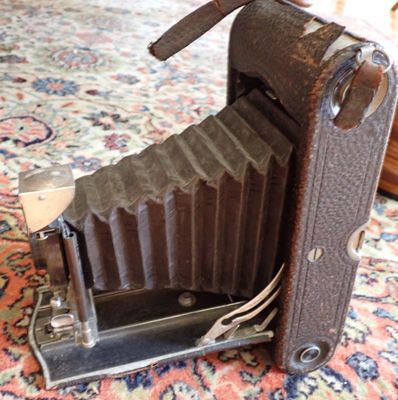an old camera sitting on a rug on the floor