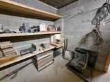 a room that has a lot of shelves and a stove in it