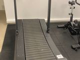 a treadmill and a stationary bike in a gym