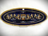 a blue and gold platter with a lion design on it