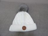 white cable knit beanie with grey pom pom