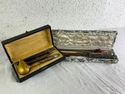 a gold spoon and a silver spoon in a black case