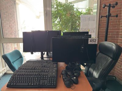 a computer desk with a keyboard and a monitor on it