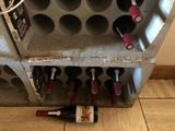 many bottles of wine in a wine rack on the floor