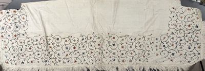 a white table cloth with fringes on top of it