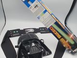 a darth vader helmet and a darth vader light saber on a table