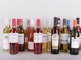 many bottles of wine that are lined up on the table