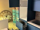 a kitchen with blue cabinets and a sink in it
