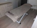 a massage table with a towel on it in a room