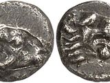 a silver coin with an image of a horse and rider on it