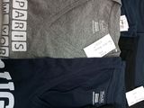 a lot of t - shirts that are on a table