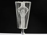 a wire sculpture of a vase on a table
