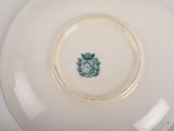 a white plate with a green crest on it