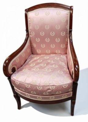 une chaise rose posée sur une surface blanche