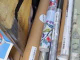 many rolls of wrapping paper sitting on top of a window sill