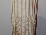 a tall vase that is sitting on a wooden table