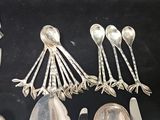 a lot of silver spoons and spoon spoons on a table