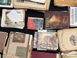 many old books on a table with a black table cloth