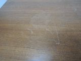 a wooden table with a brown stain on it