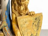 a statue of a lion holding a shield and shield