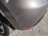 a close up of a car ' s rear end with a tire
