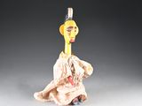 a figurine of a woman with a hat on her head