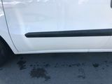a small white car parked in a parking lot