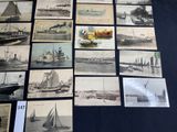 many pictures of boats on display on the table